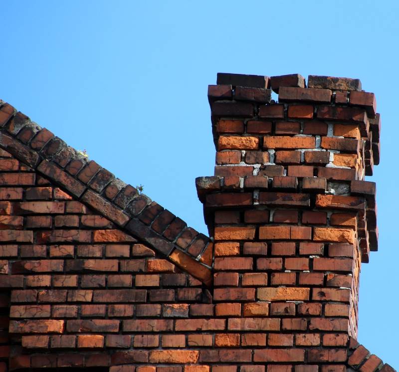 Damaged chimney on an Evergreen Park home showing cracks and missing mortar